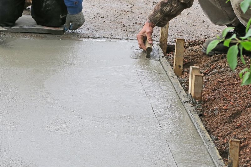 Concreter finishing a resurfaced driveway in Townsville
