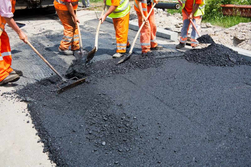 asphalt paving installation by concrete workers