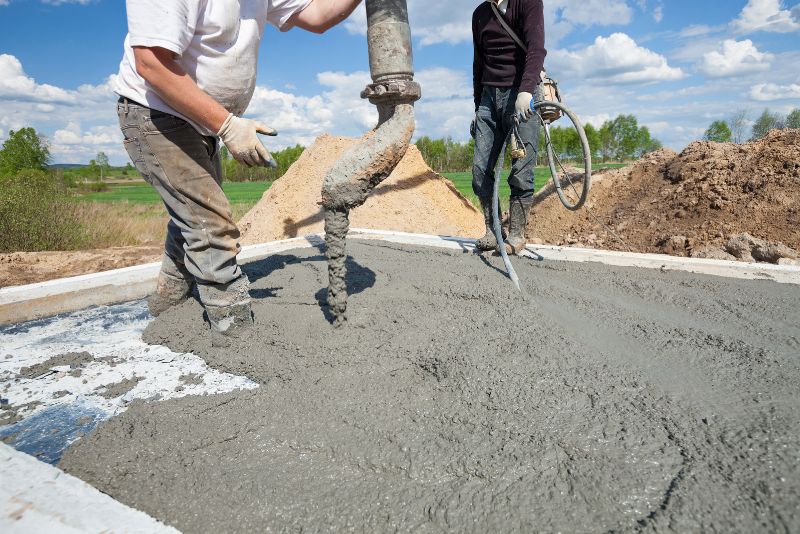 concrete worker pouring concrete