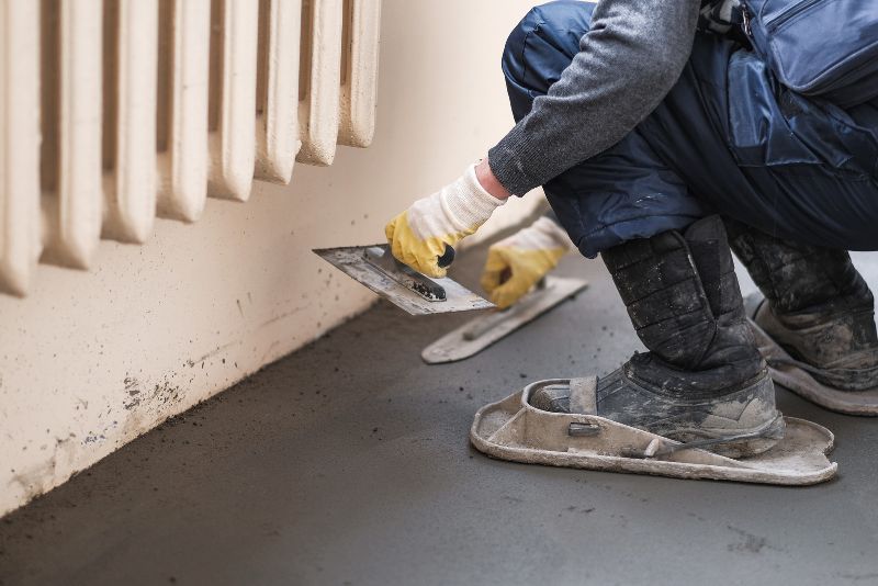 Concreter smoothing a fresh concrete finish